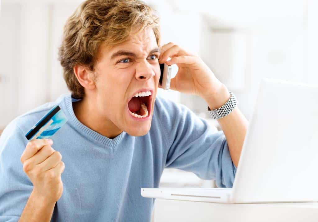 Man angry at customer service holding his credit card
